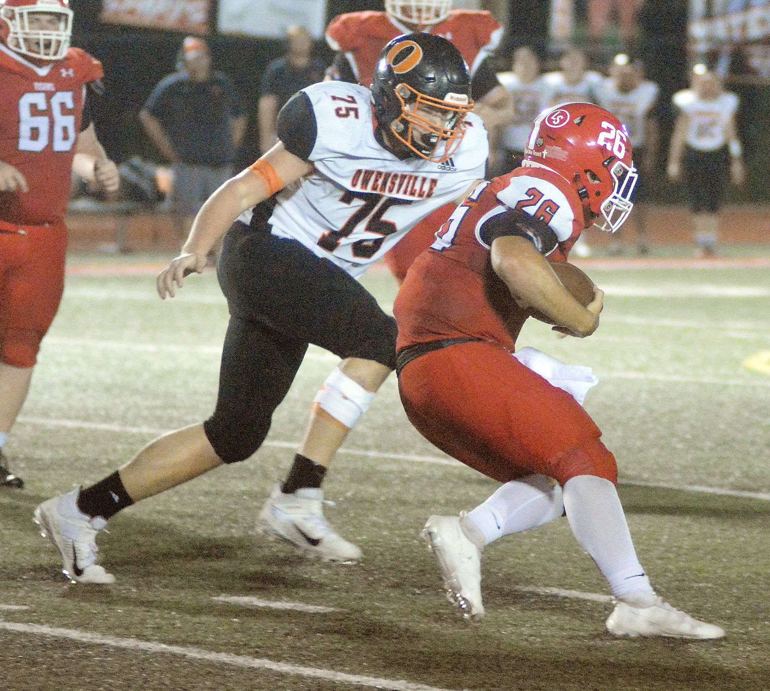 Garrett Crosby (left) closes in on St. James Tiger quarterback Cooper Harlan for one of his five tackles on the night. Brent Helmig led the Dutchmen defense with a team-high 13 total tackles.